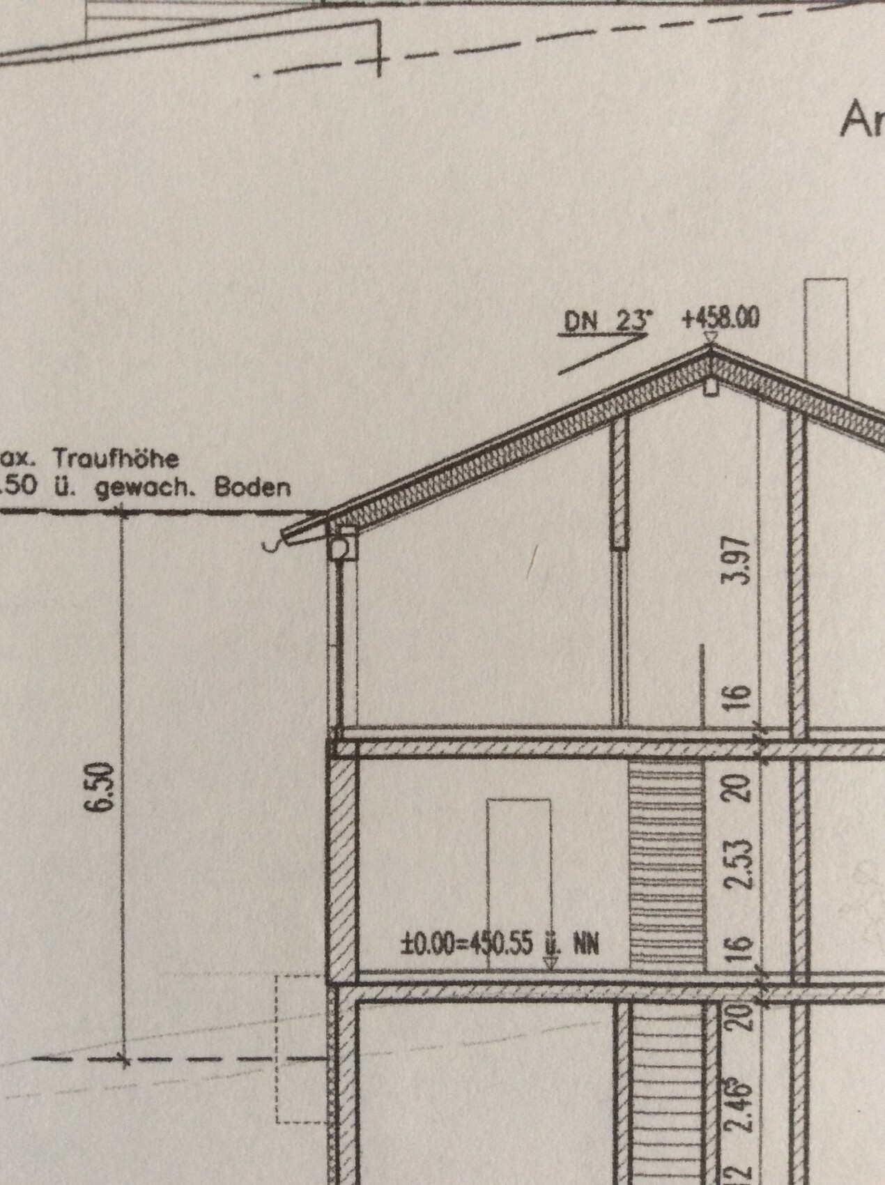 Cross-section view of a house with pitched roof, multiple floors, and staircase.