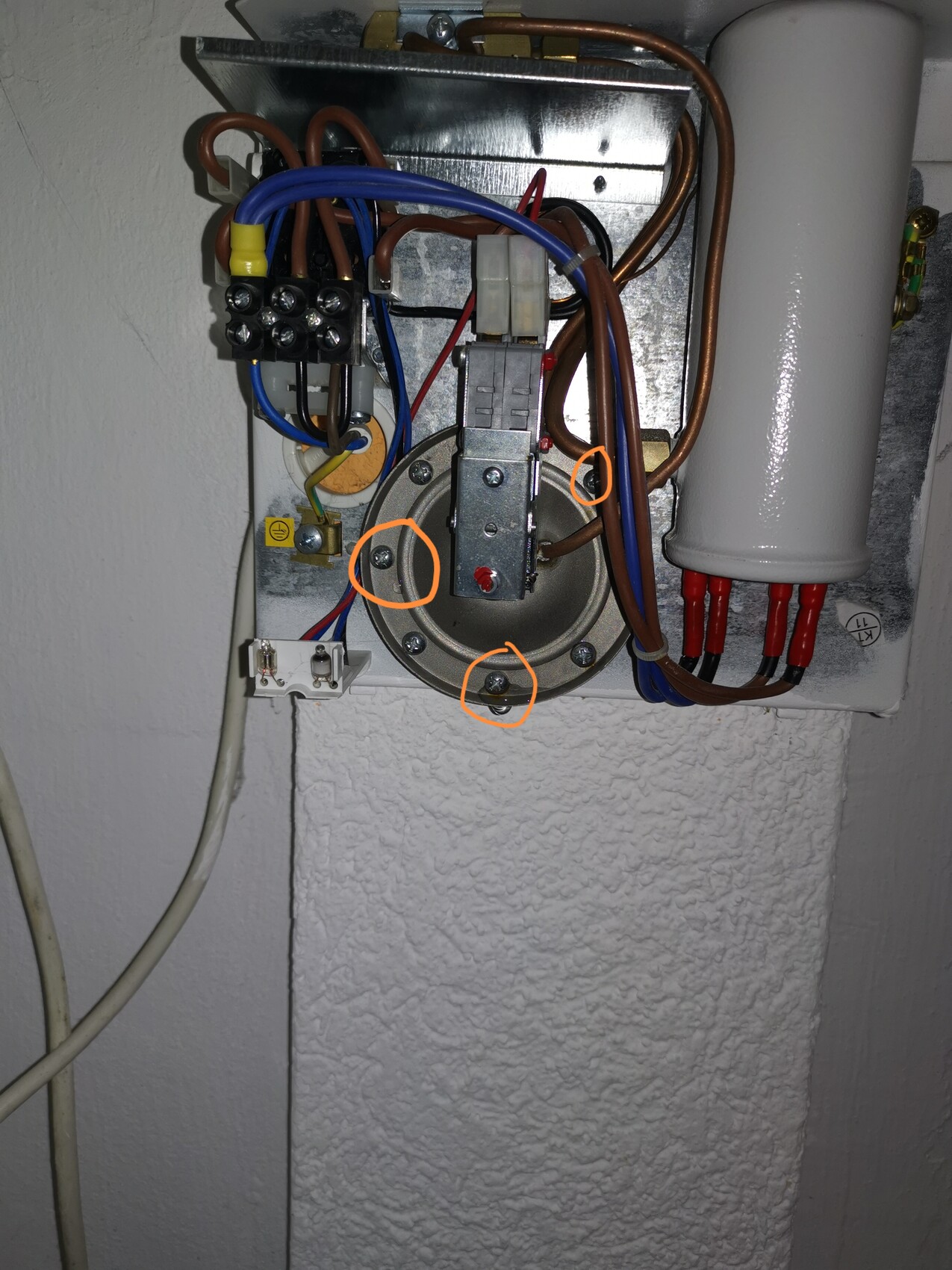 Electrical control panel with many wiring connections, transformer and cylindrical capacitor.