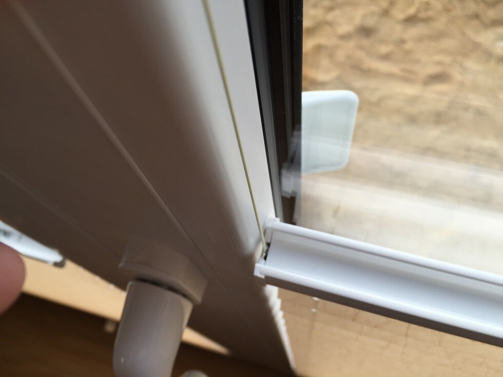 Close-up of a white uPVC window frame with gasket and glass
