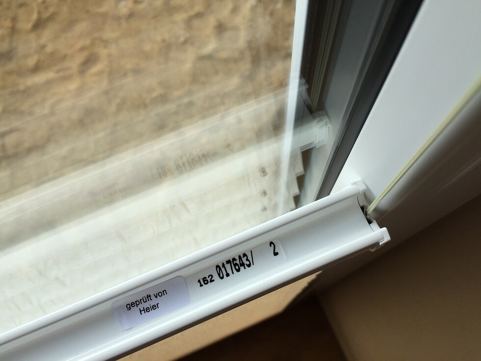 White window frame with gasket, interior view, label on the sash