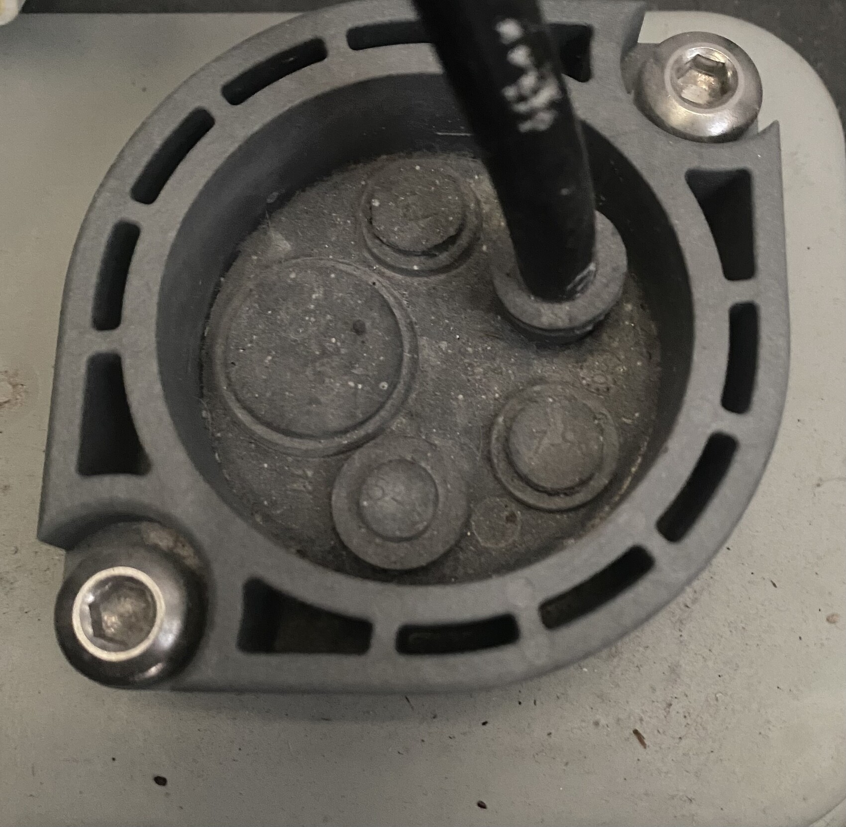 Round building services enclosure with cable connection and screw fittings on a pump