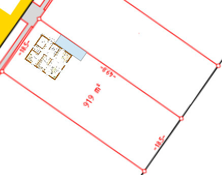 Plot plan with red boundary line, building area marked in blue and measurements