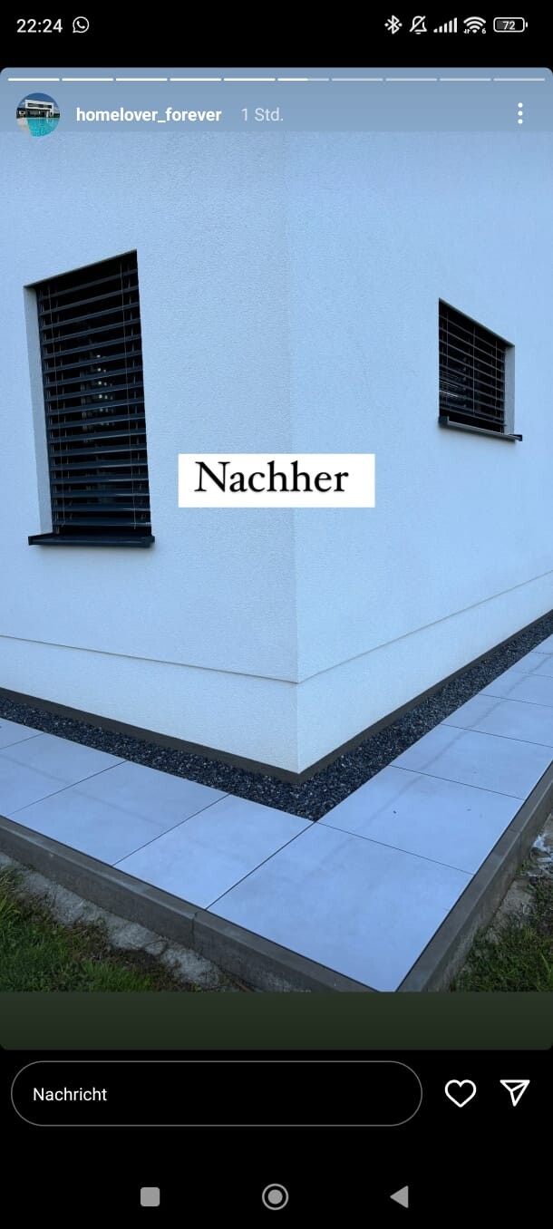 Light blue building wall with two black louvered windows; afterward in the center.