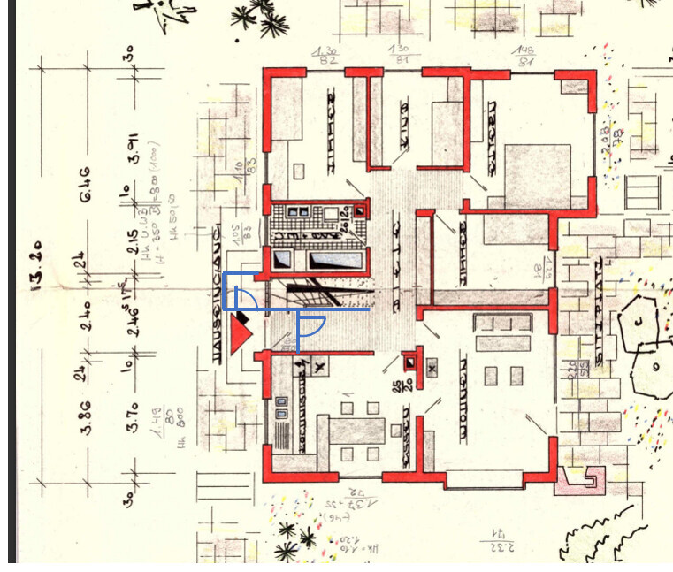 Floor plan of a house with red walls, interior rooms, stairs and furnishings.