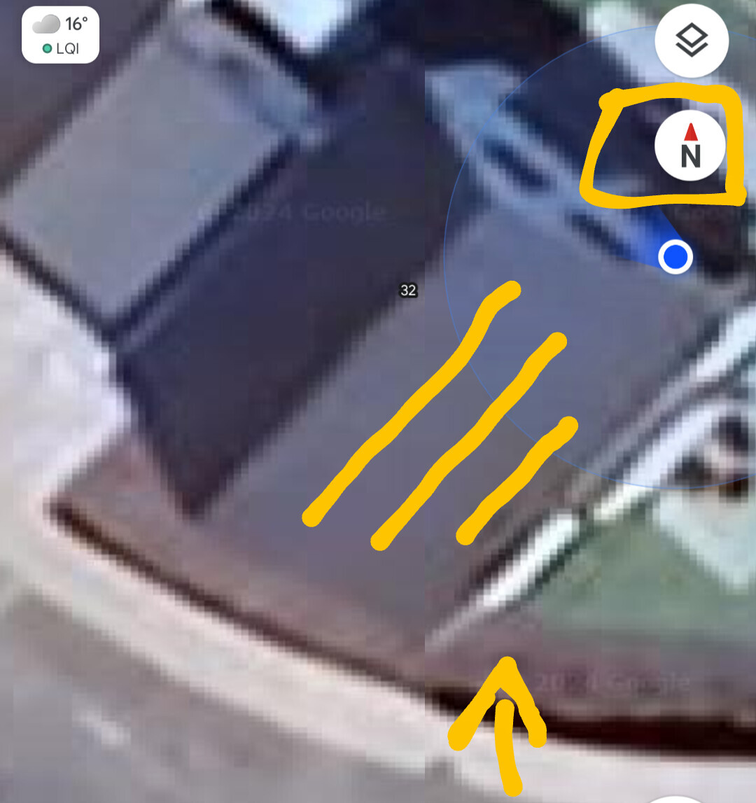Satellite view of a building complex with map overlay and blue location marker.