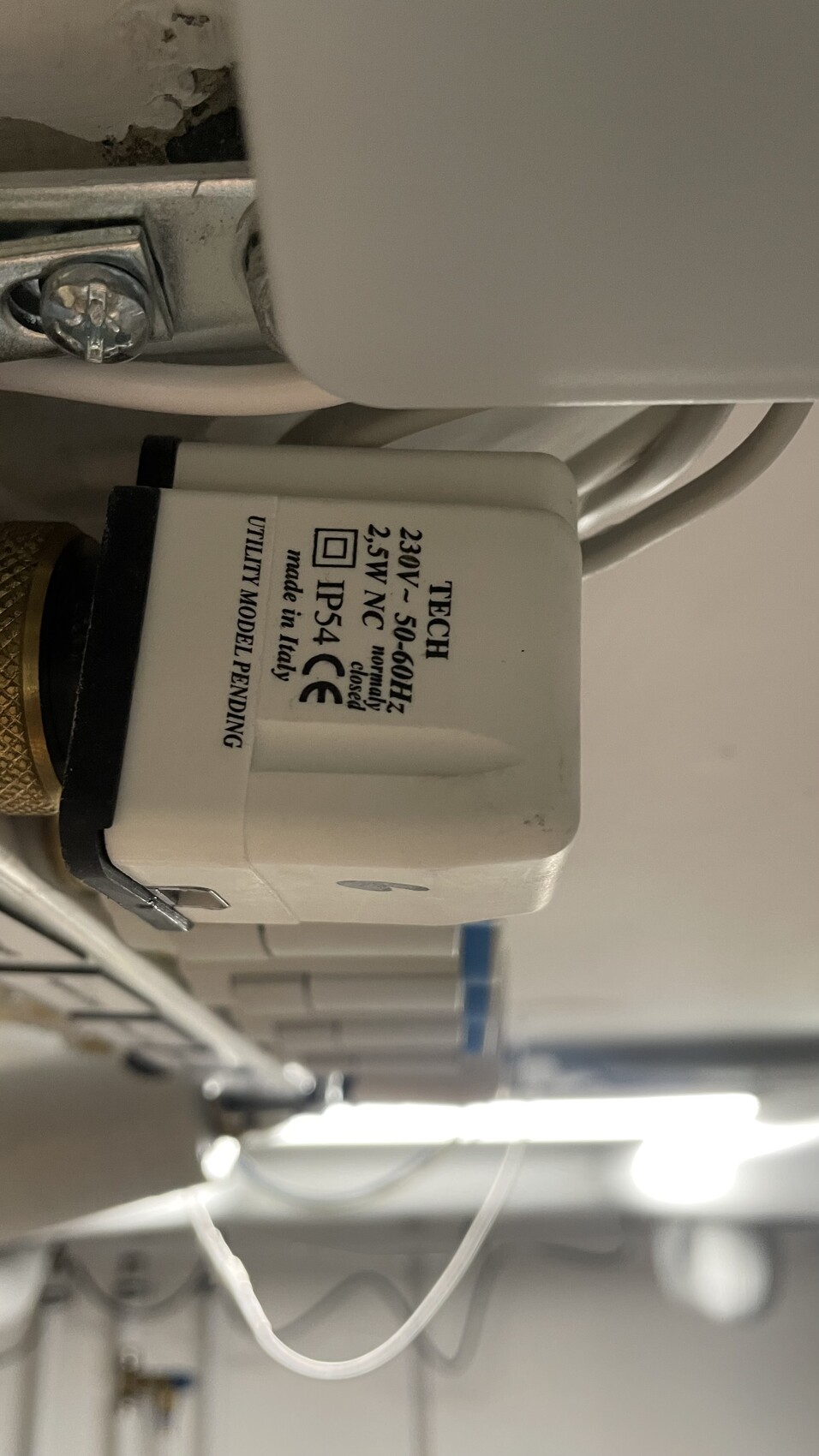 Close-up of an electrical relay/switch with rating plate: 230V, 2.5W, NC, IP54