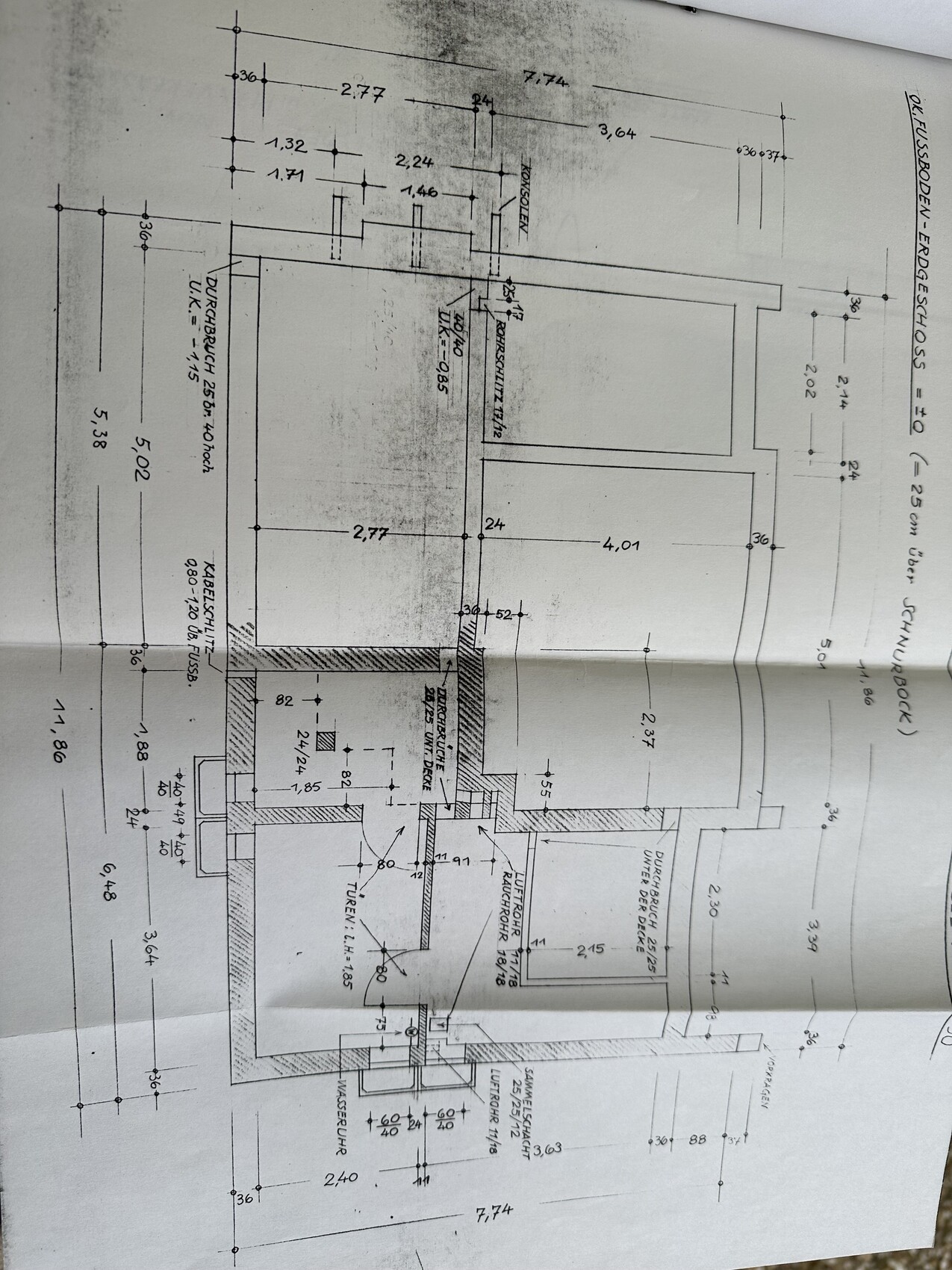 Architectural floor plan of a building with interior walls, doors, staircases, and dimensions.
