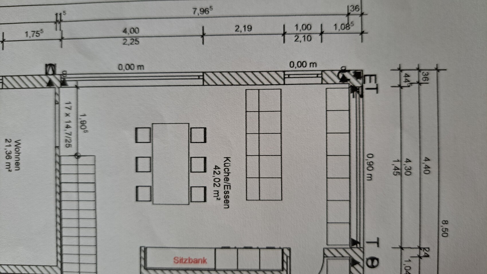 Floor plan of a room with kitchen/dining area and dining table with chairs.