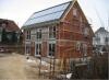 Timber frame house under construction: Timber frame construction with scaffolding and construction surroundings