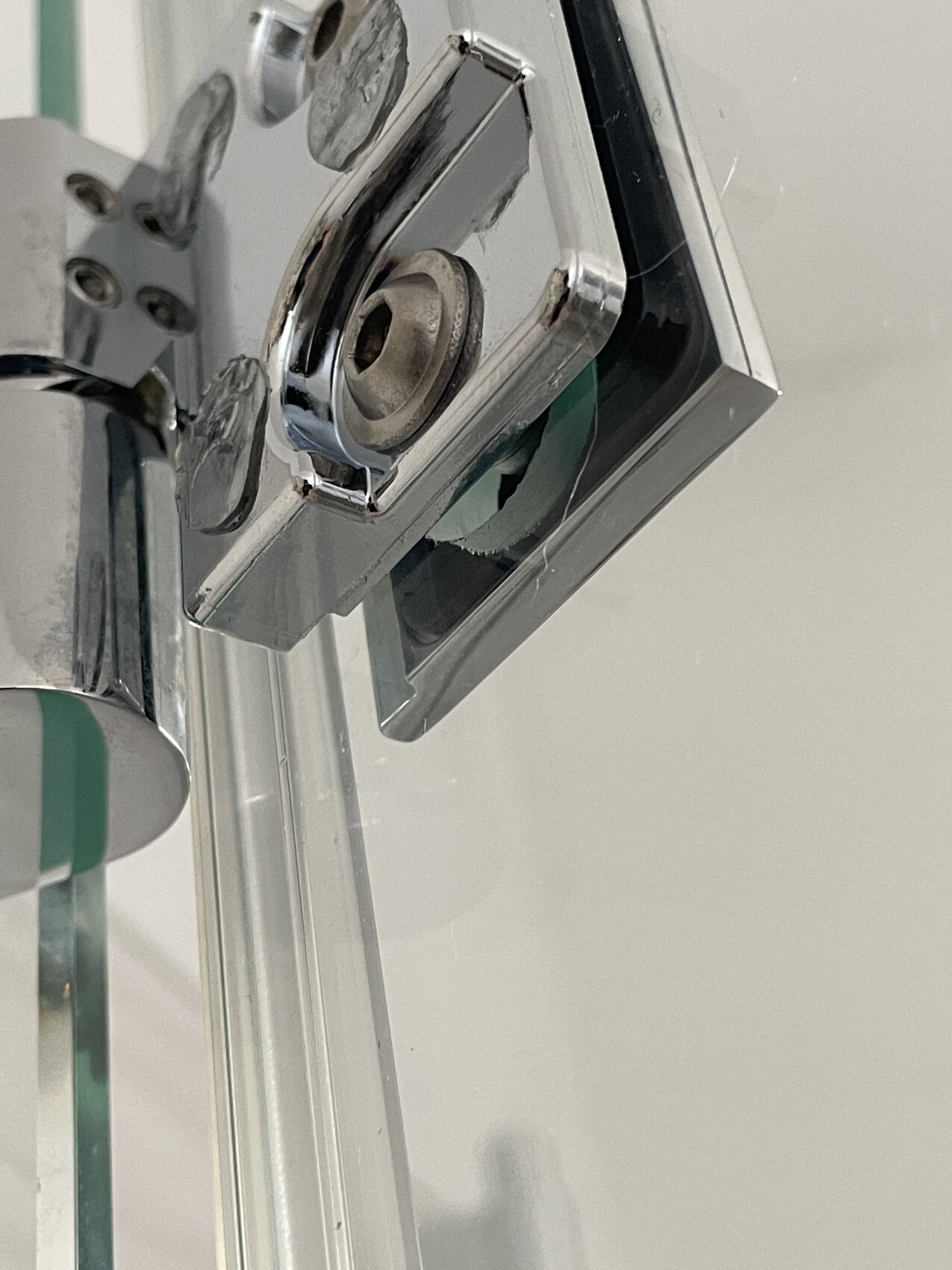 Close-up of a door lock on the door frame, chrome-colored, visible locking mechanism.