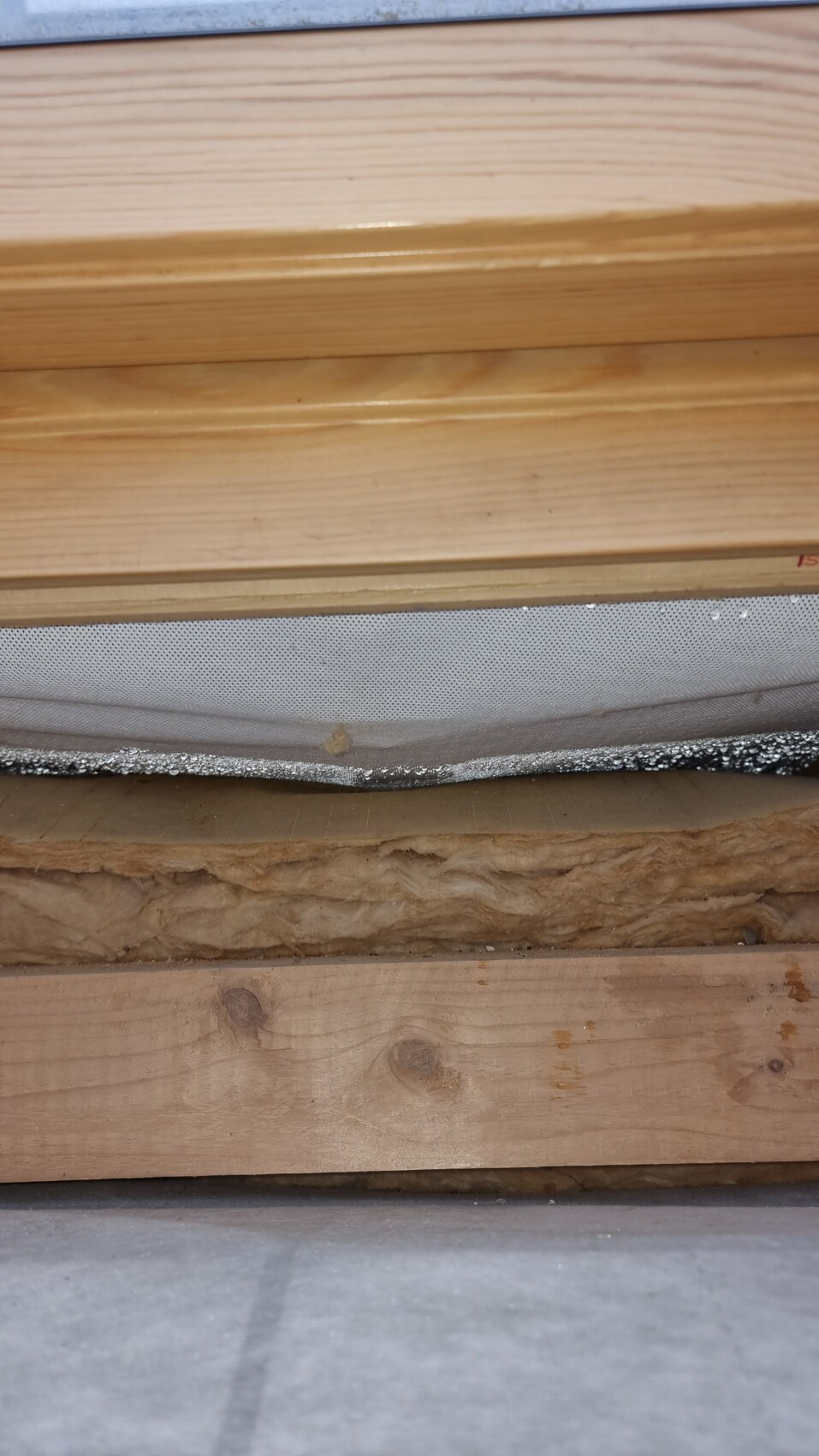 Cross-section of wall build-up with wood cladding, insulation, and battens.