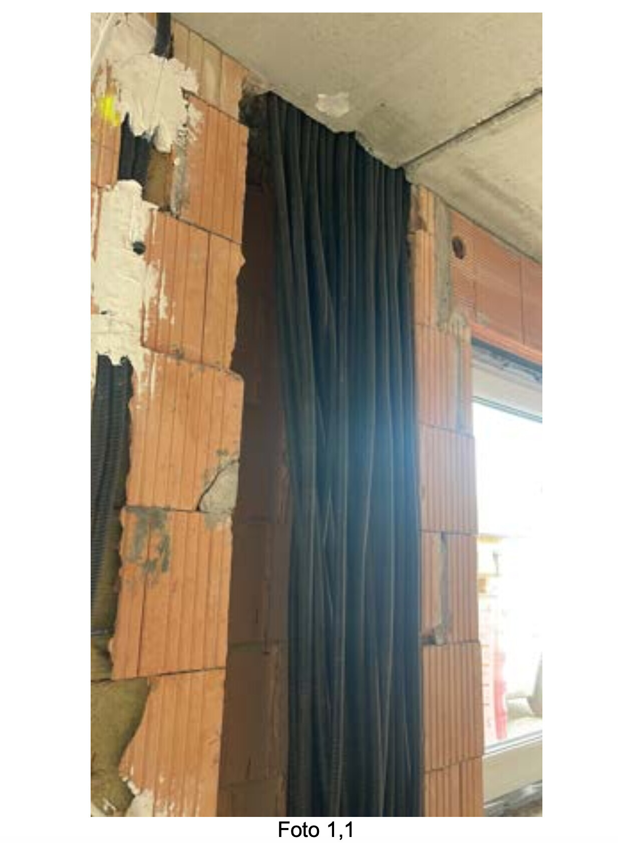 Construction site with exposed brick wall and cables during interior work