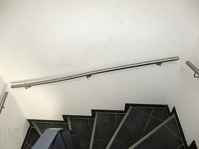 Interior: dark staircase with metal handrail in the stairwell