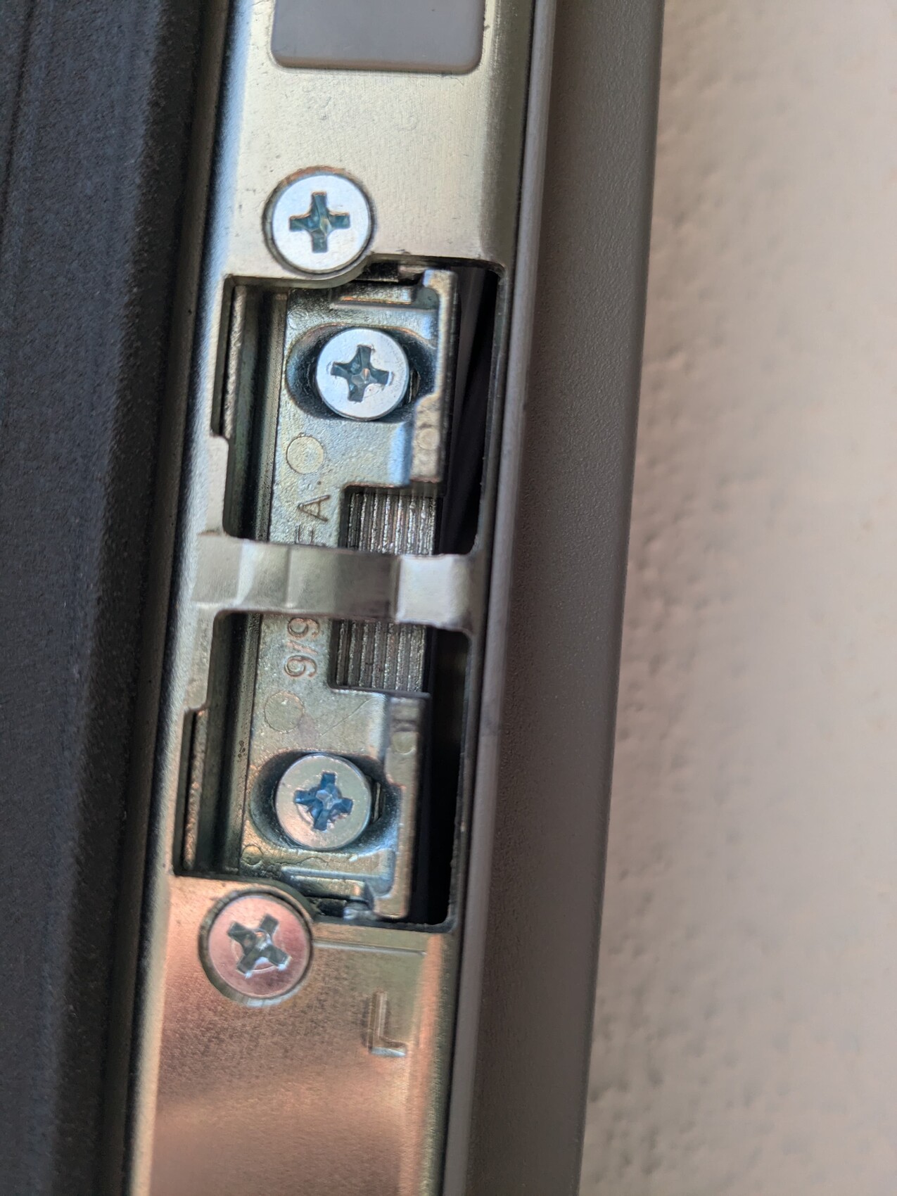 Close-up of door fitting with screws and metal latch