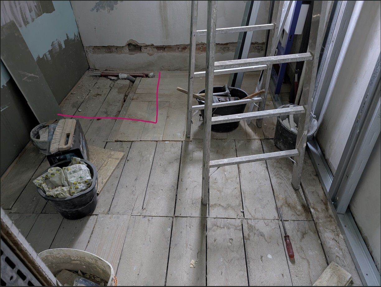 Interior construction site: wooden plank floor, ladder, bucket with tools, pink marking on the floor.
