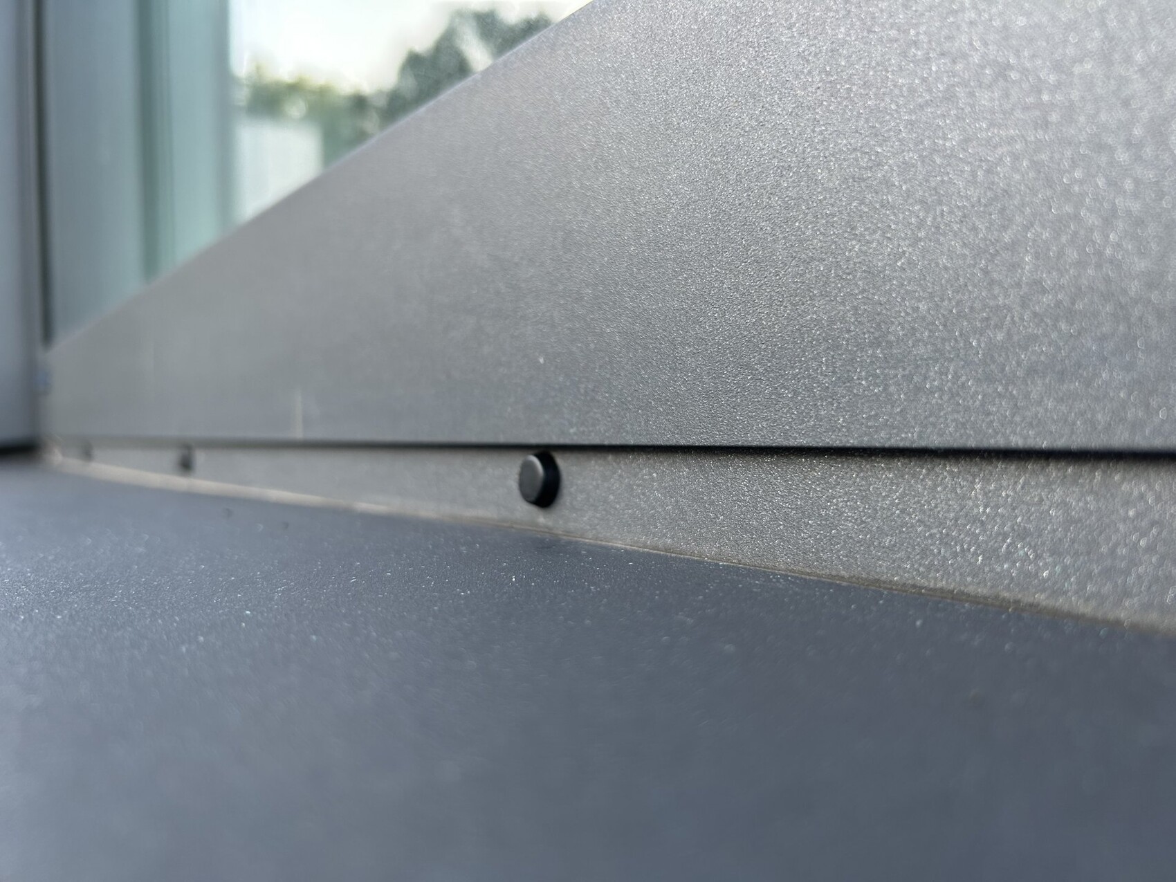 Close-up of a metal cladding in the window area with seam and small black covering
