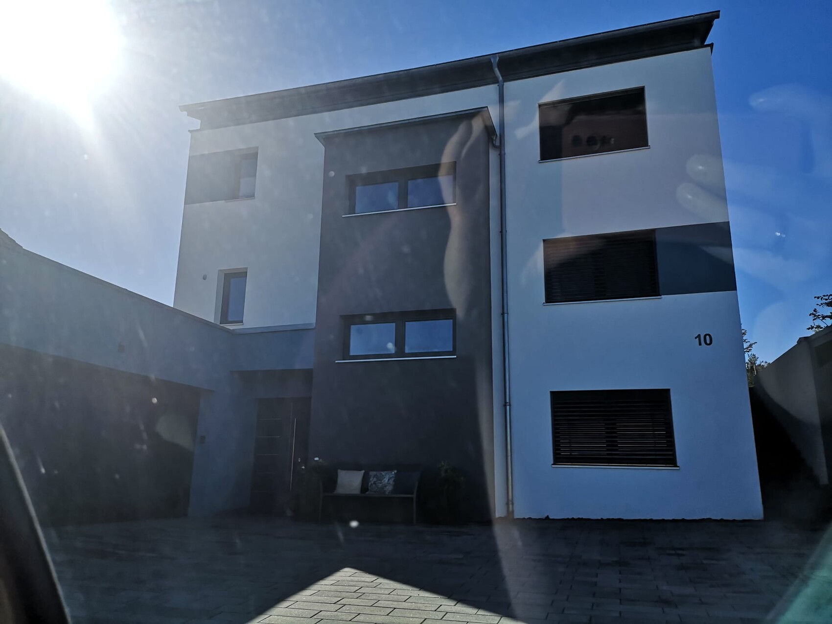 Modern two-story house facade in white and gray, front view