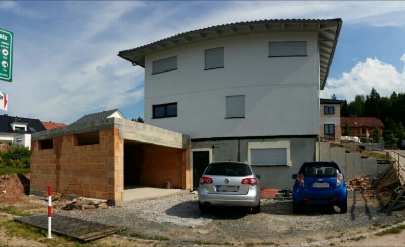 Modern two-story house with a masonry garage; two cars in front.