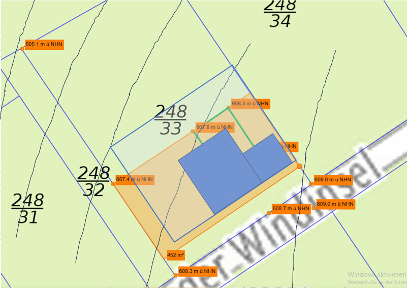Site plan of a plot showing building area, boundary lines, and elevation details