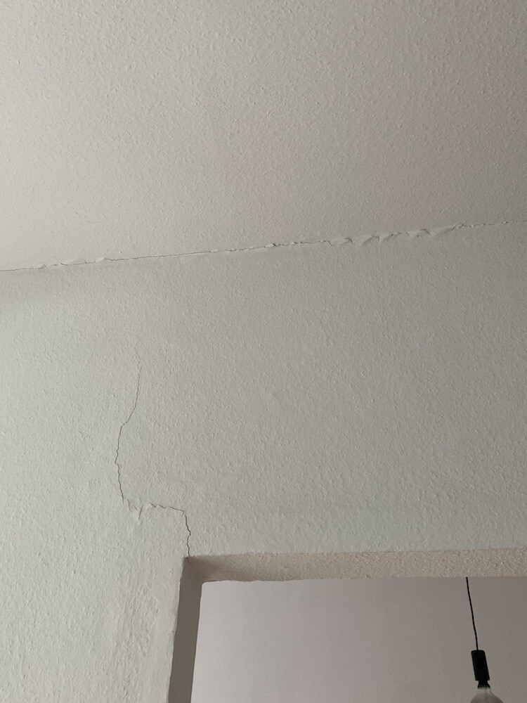 Interior wall and ceiling with cracks and unevenness