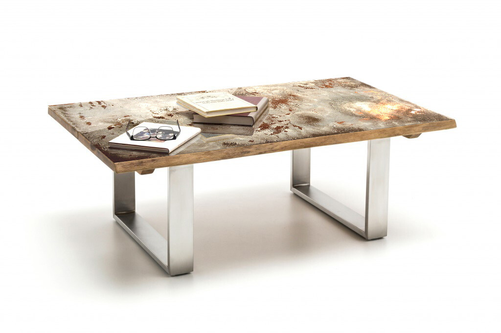 Rusty metal table with legs, glasses and books on top