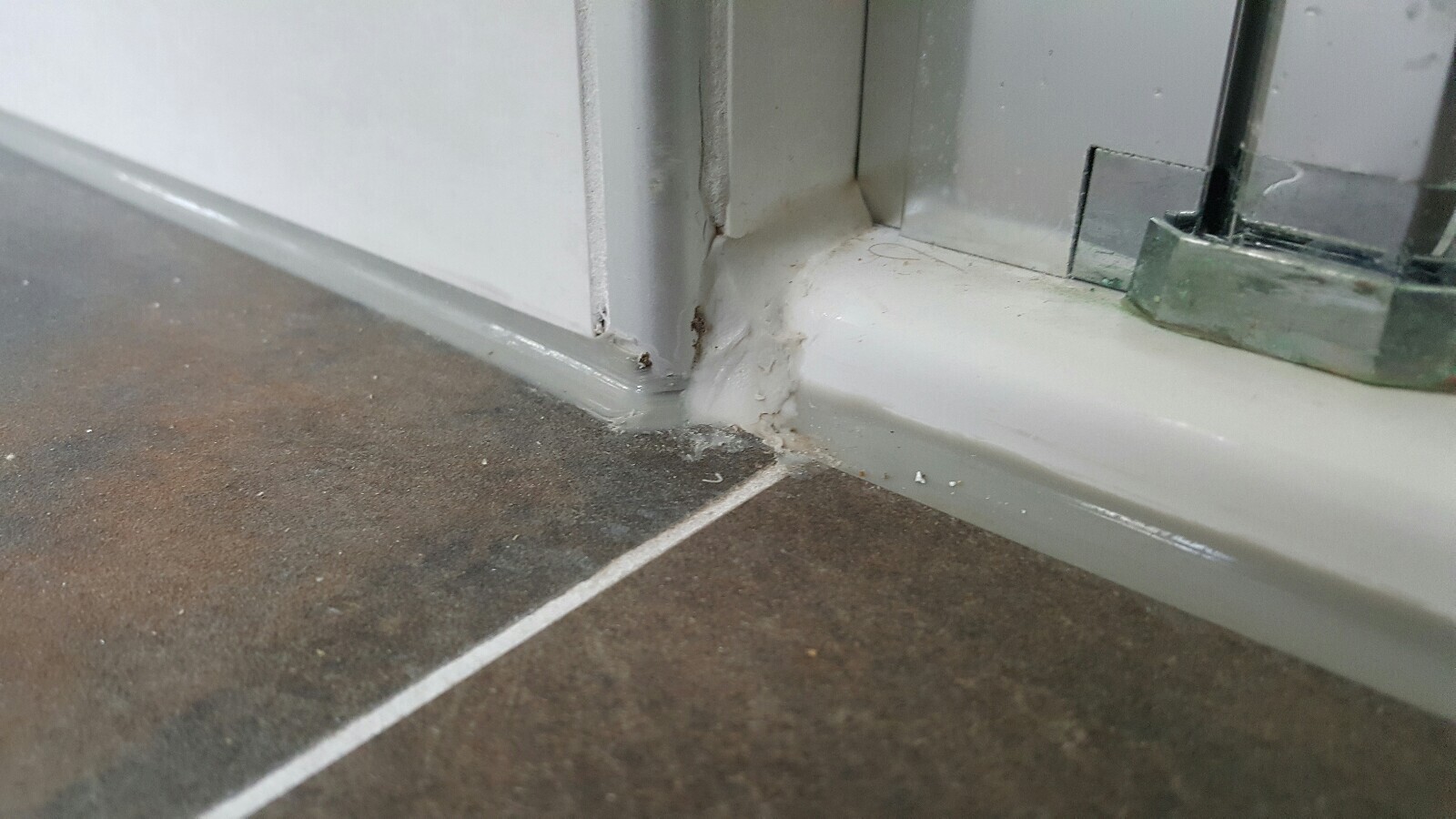 Close-up of a door frame on the floor covering with sealant and dust